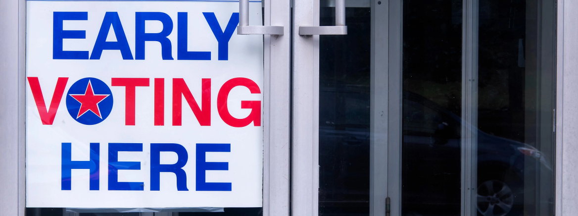 An early voting sign on a storefront door.