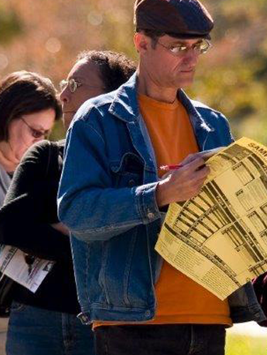 A photo of County voters standing in line at a precinct.