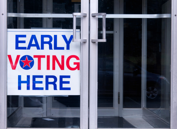 An early voting sign on a storefront door.