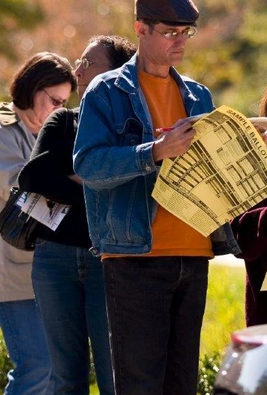 People reviewing election ballots